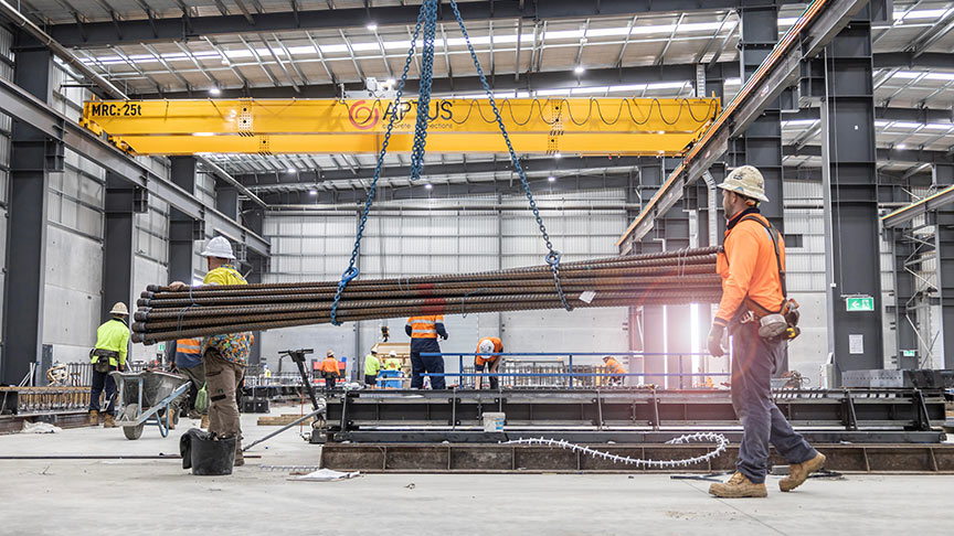 Workmen inside Toowoomba warehouse manufacturing concrete stair cores