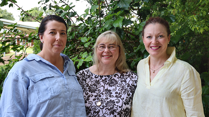 3 mobile women's health nurses outside in front of green hedge