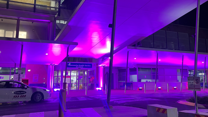 The front entrance of Toowoomba Hospital with glowing pink lights