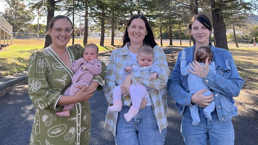 Three women holding their newborn babies.
